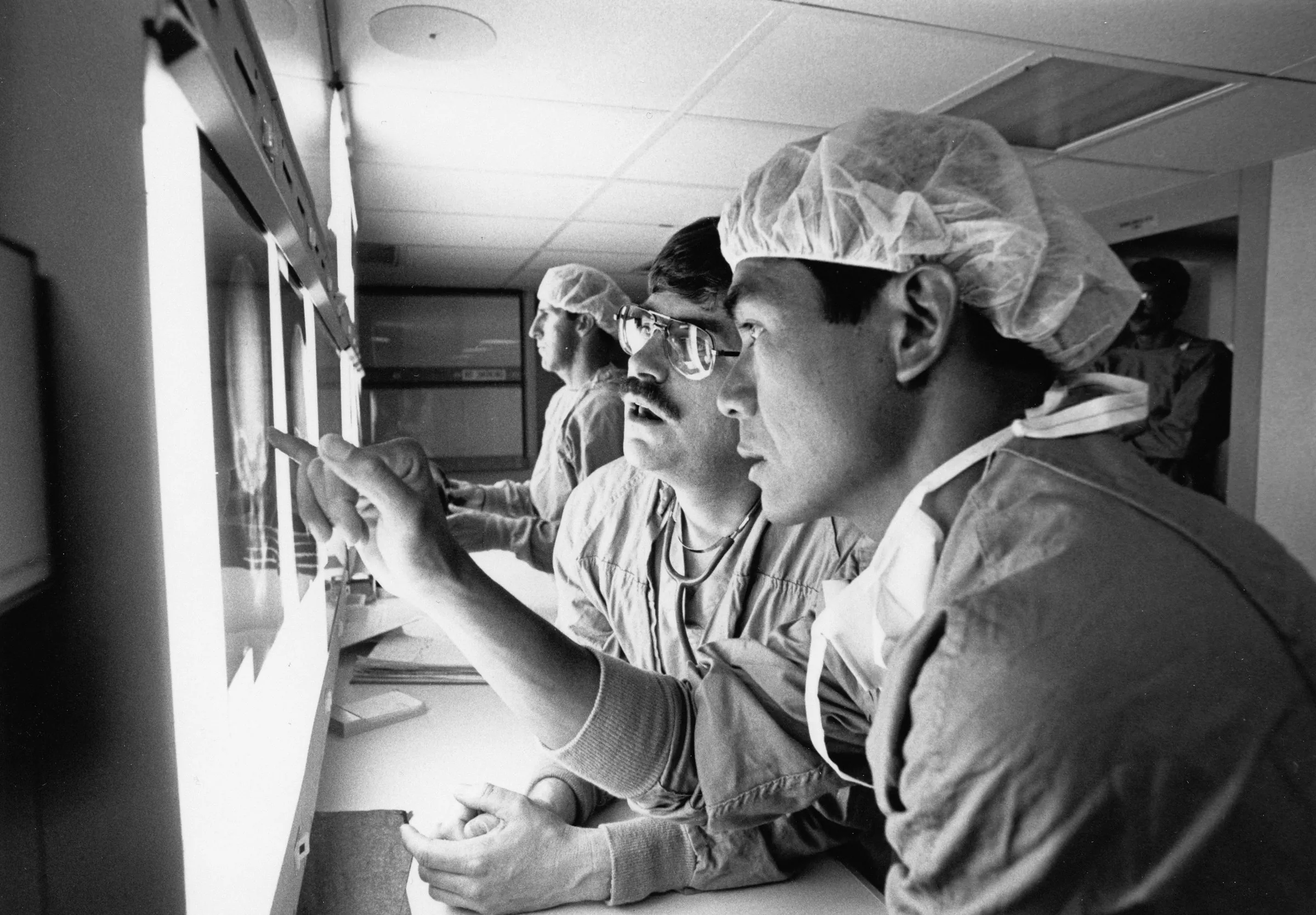 Surgeons reading X-rays on a lightbox