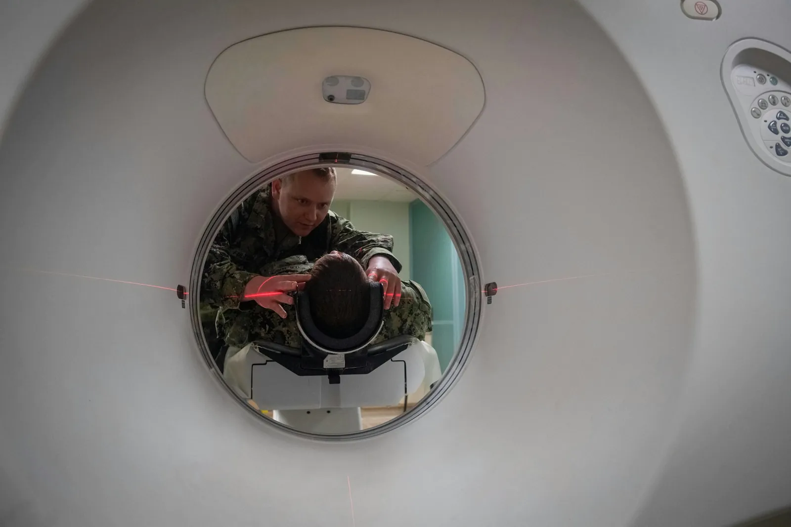 Looking into a CT scanner, with a chest film inside the ring